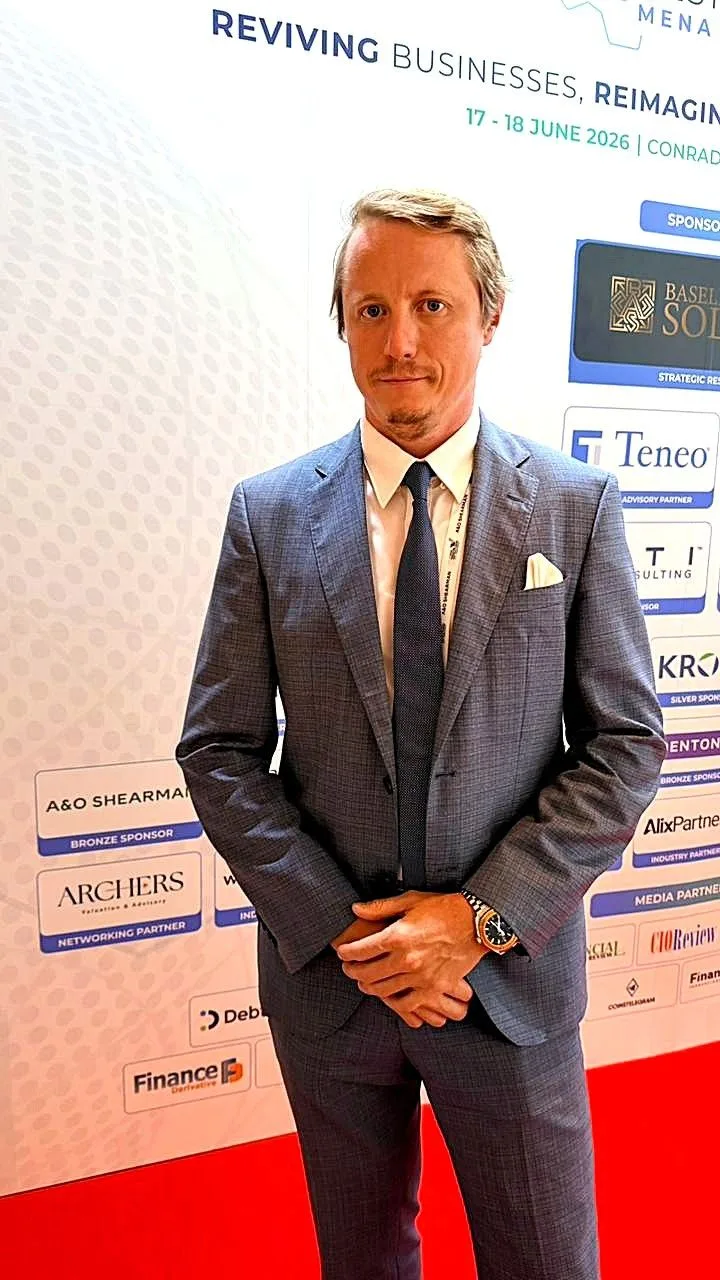 Rus Kolinko in front of the FRC 2026 sponsors wall, where Archers is listed as Networking Partner
