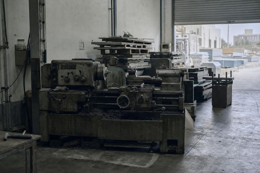 A metalworking lathe in use in a light-industrial unit in a Dubai warehousing district