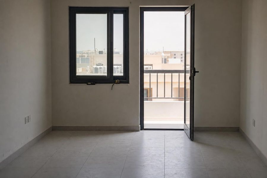 An unfurnished apartment being inspected for valuation, a tape measure left on the windowsill